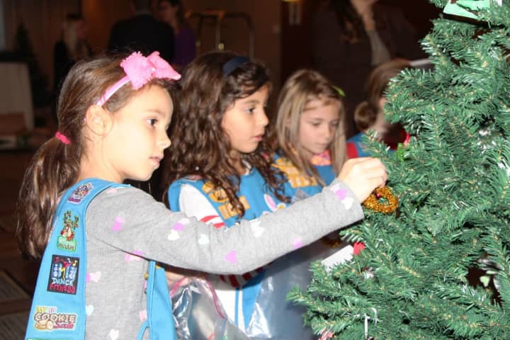 Girl Scouts from Hasbrouck Heights adorn Christmas trees for the first-ever 501(c) Trees event at the Hilton.