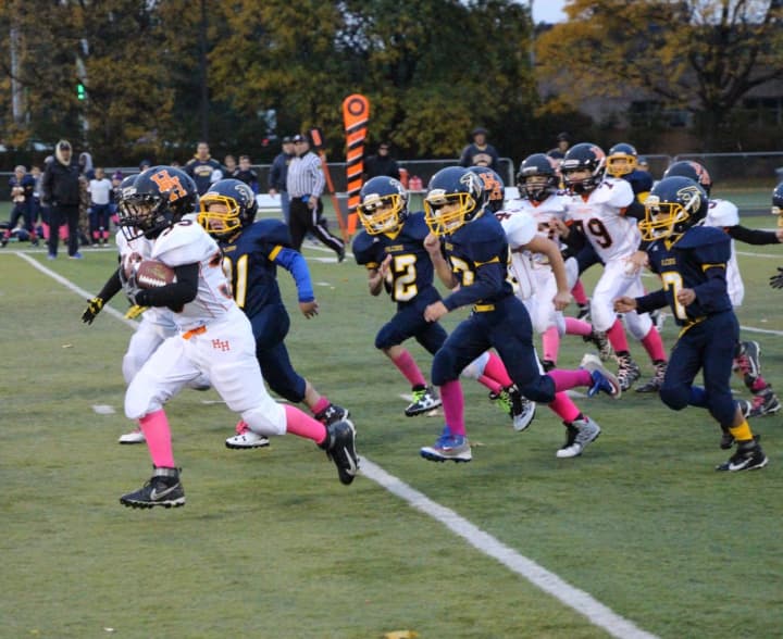 Pee Wee Aviator Nick  Grasso heads to the end zone in the second quarter of the game against Saddle Brook.
