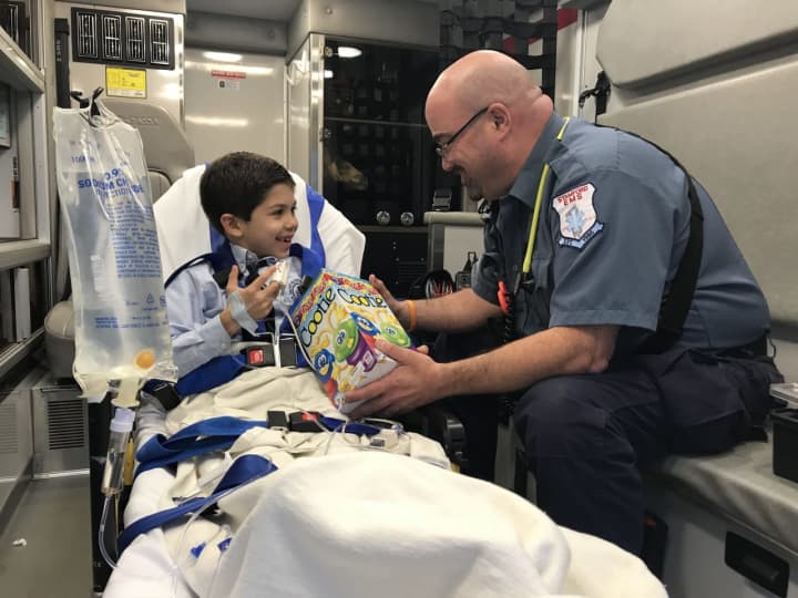 James, age 6 and Pete Kessler, President of the Stamford Paramedic Association, Local R-1 684, a unit of IAEP