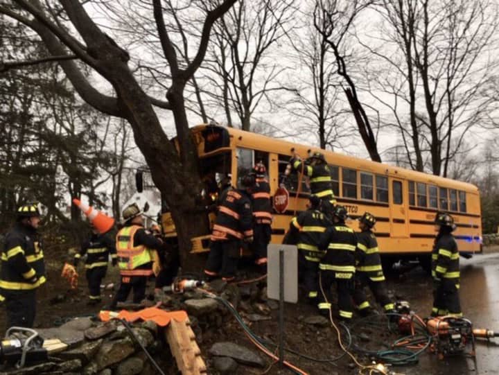A school bus driver was trapped and students slightly injured following a crash.