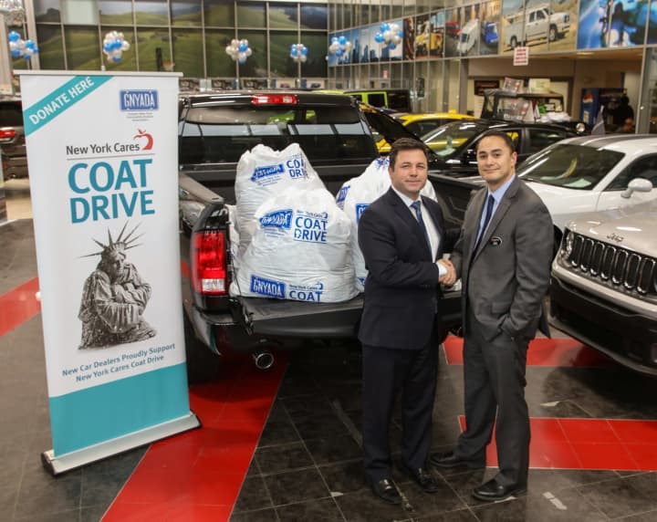 Eastchester Chrysler Jeep Dodge director Alan Katz with coats collected for New York Cares Coat Drive.