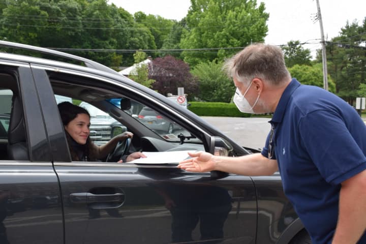 A Bronxville Middle School eighth-grader receives a certificate during a drive-through celebration Thursday, June 18.