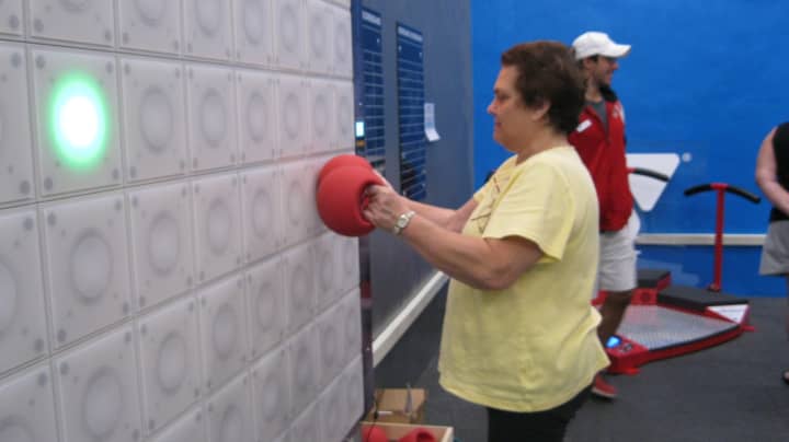 Member Evelyn Stier exercising with the ExcerZone&#x27;s T-Wall. 