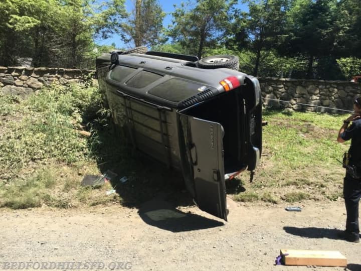 Members of the Bedford Hills Fire Department and Police Department helped a driver who was pinned by their SUV after a rollover.