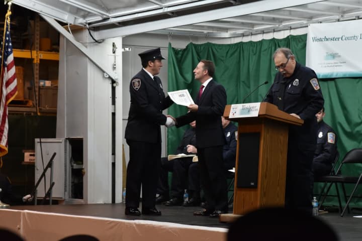 Westchester County Executive Rob Astorino congratulates one of the recent graduates at the fire academy in  Valhalla.