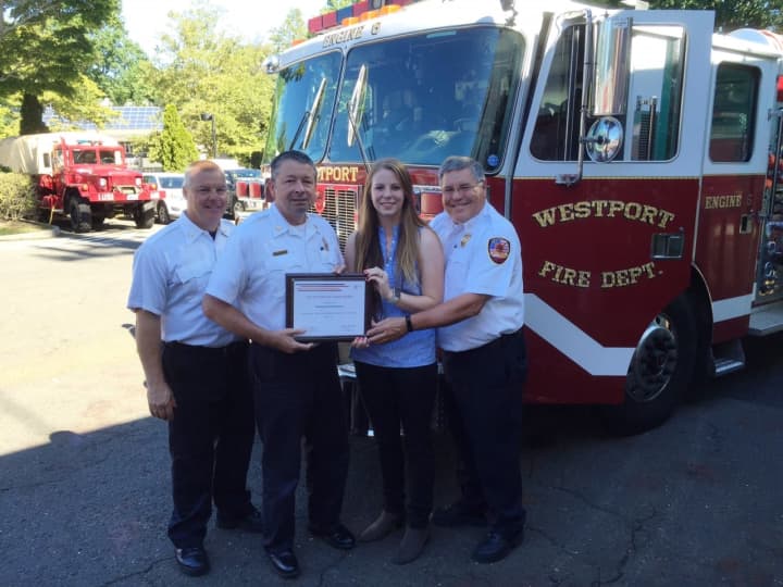 FM Global representative Meaghan Paul presents the Westport Fire Department with a $4,000 prevention grant.