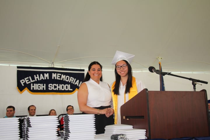 Candice Ripoll, president of the Council of the PTAs, presents Alice Xue with the second place Fairclough Award at Pelham Memorial High School&#x27;s 2016 Commencement.