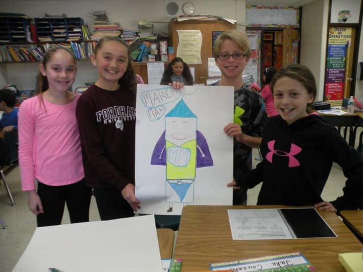 A group of fifth-graders from Austin Road Elementary School show off their design idea for a balloon float for the upcoming Macy&#x27;s Thanksgiving Day Parade.