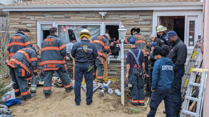 Members of the Yonkers PD and the city&#x27;s fire department conduct a rescue operation to free a person trapped in a trench at 15 Frederic Place.