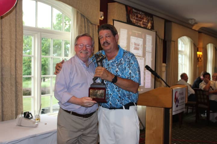 Michael O’Connor of Coldwell Banker Residential Brokerage&#x27;s Yorktown Heights office presents a trophy to Rich McNichol of McNichol Home Inspections. McNichol’s foursome won the annual charity tournament.