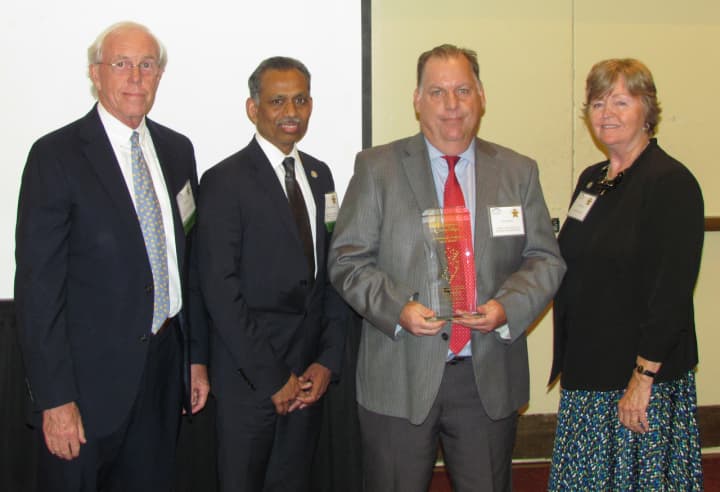 Hudson County Workforce Development Board Executive Director John Fugazzie, center, receives the 2016 Community College Spirit Award from the New Jersey Council of County Colleges.