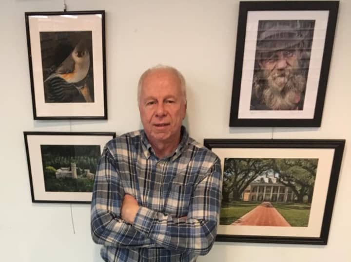 Wayne Ross with a selection of his pictures on display at the River Edge Public Library.