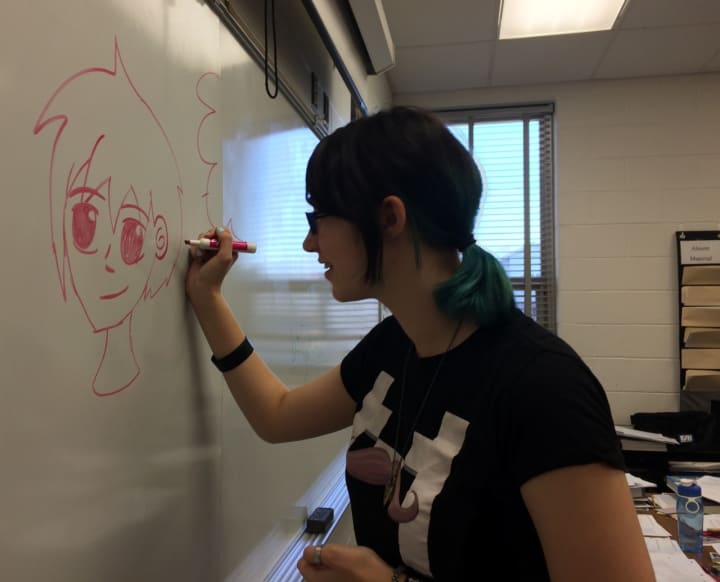 Elmwood Park sophomore Nicole Appel draws an anime style character on the board. 