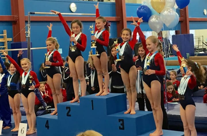 Darien Level 3 gymnasts topping the podium in the age eight All Around were from left, Lindy Mueller, Penelope Arredondo, Anna Altier, Ava Licata, Sydney Berk, Annelise Enters and Sophia Gaffer.