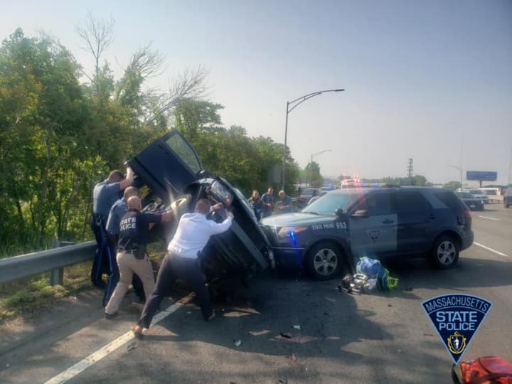 Rescue workers work to free a 29-year-old woman from a crashed car Monday morning, May 22. The Westfield driver was taken to the hospital with non-life-threatening injuries.