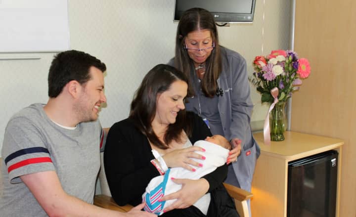 New family joined by nurse from the Family Birthing Center at Good Samaritan Hospital.