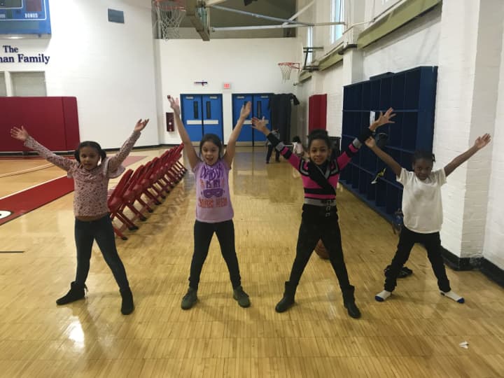 Young members of the Cardinal Shehan Center do jumping jacks as part of the Fitness for Life program supported by the Rotary Club of Bridgeport Foundation.