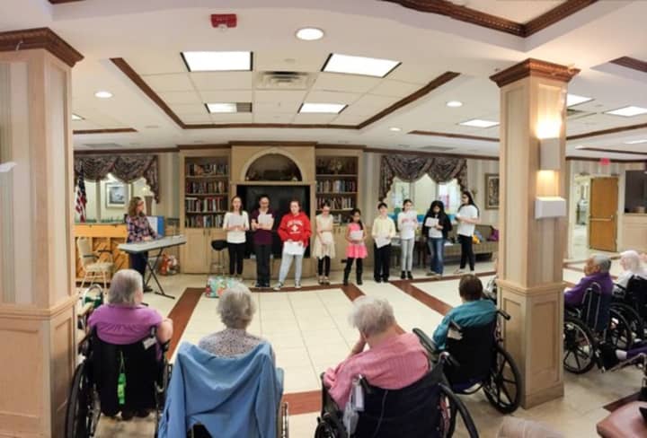 The Felix Fest Middle School Glee Club performing at the Northern Manor Nursing Home.