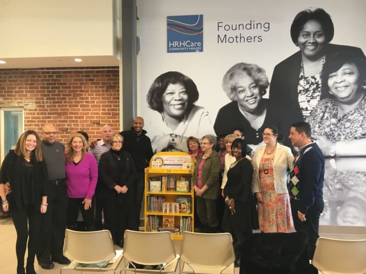 Peekskill Mayor Andre Rainey, HRHCare EVP and Founding Mother, Rev. Jeannette Phillips, and other speakers at the Golden Bookcases event at HRHCare Peekskill.