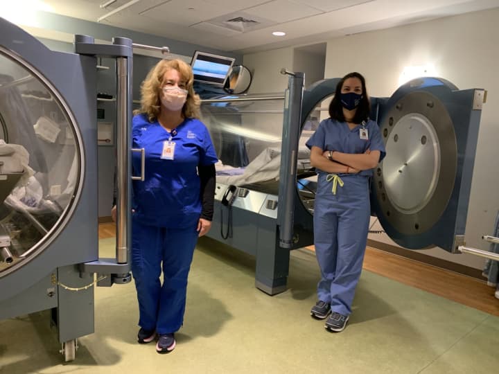 Greenwich Hospital is treating COVID-19 patients with hyperbaric oxygen therapy
administered by Ellen Stacom, RN, (left) and Dr. Sandra Wainwright.
