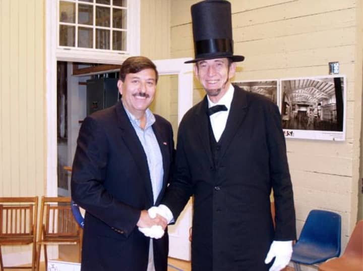 Former mayor and history buff John Testa, left, shakes hands with former teacher, Michael E. Griest, at the Lincoln Depot Museum in Peekskill. Griest, who frequently portrayed Abe Lincoln during city events, died Tuesday at the age of 77.