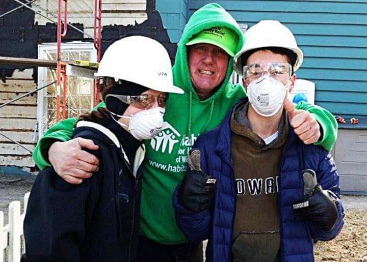 Participants pose -- with varying levels of enthusiasm -- at a Habitat for Humanity of Westchester project.