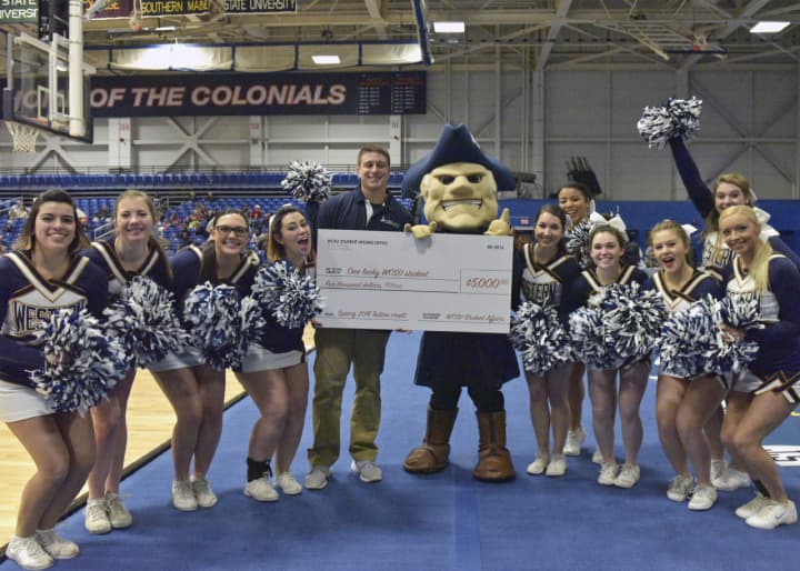 Alfiere is pictured with the university’s mascot, Colonial Chuck, and members of the WCSU cheerleading squad.