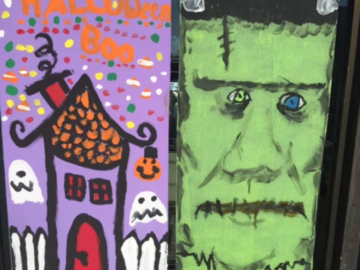 Kids painted the windows of storefronts with Halloween images.
