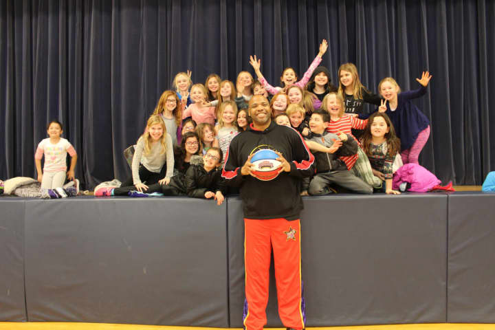 &quot;Big Mike&quot; of the Harlem Wizards poses for a photo with Katonah Elementary School students.
