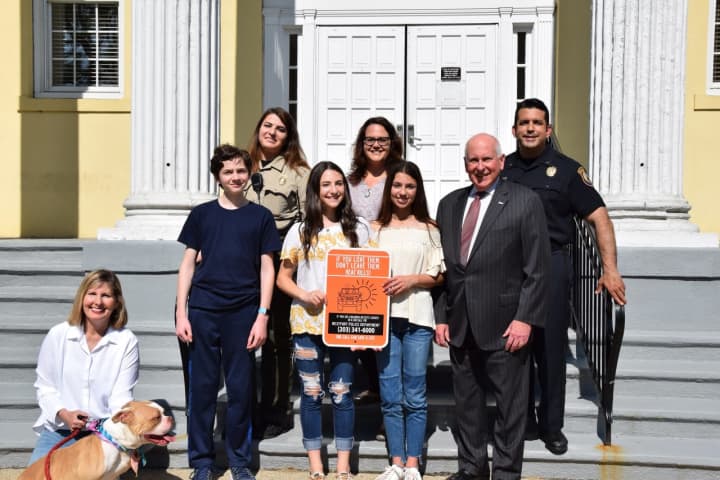Julie Loparo, left, poses with Brandon Malin, Jordi Katz, Ali Green and First Selectmen Jim Marpe. In the back row are Animal Control Office Gina Gambino and Carla Eicher and Deputy Police Chief Vincent Penna.