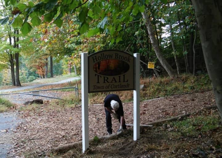 A worker installs the sign marking the beginning of the town of Cortlandt&#x27;s brand-new Hollow Brook Trail. It will be officially opened at 4:30 p.m. on Thursday, Oct. 20.