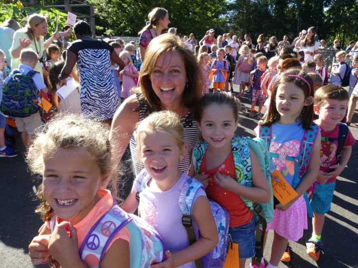 <p>Holmes School Principal Paula Bleakley welcomes kindergarteners to their first full day of school. Pictured left to right are Kate Elias, Madison Hite, Lily Ryan, Annabelle Knupp and Wes Solomon.</p>