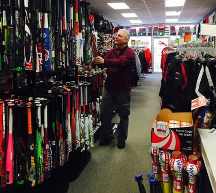 Steve Colombo, owner of Home Field Advantage, re-stocks baseball bats at the Pompton Lakes, N.J., sporting goods store.