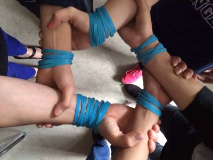 These rubber wrist bands worn by eighth-grader in Port Chester School District represent a school-wide effort to raise $10,000 for Water for Sudan, an African charity.