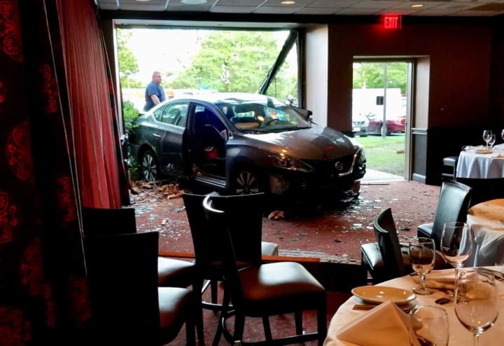 An 87-year-old driver sustained minor bruising after plowing her car through the wall of a restaurant at the Parsippany Hilton Hotel, authorities said.