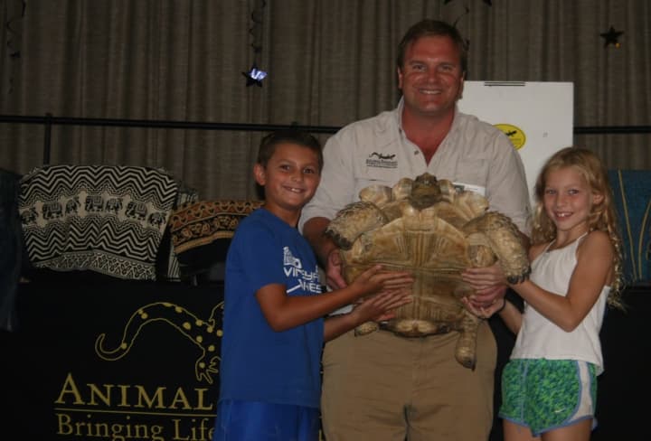 Animal Embassy&#x27;s Chris Evers shows students a huge tortoise during his visit to Royle Elementary School.