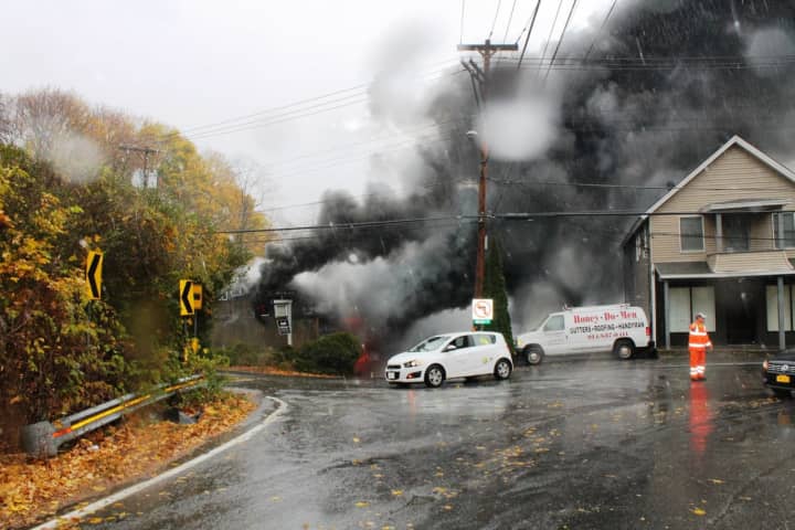 The auto body shop became engulfed in flames shortly after 1:30 p.m. Tuesday.
