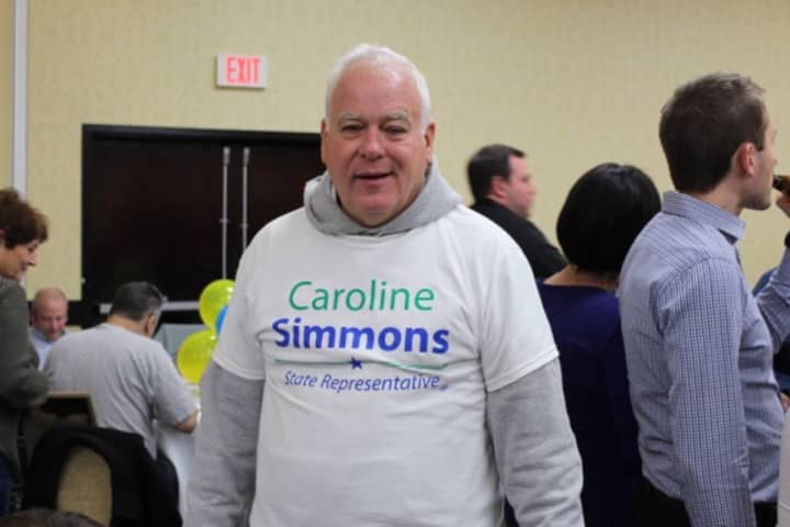 Michael Feighan, a political strategist for State Rep. Caroline Simmons, wears his allegiance on his chest.