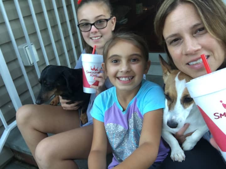Smoothie King owner Denise Cinque MacDonald, right, with her girls (from left) Lindsey and Kate, and their two dogs.
