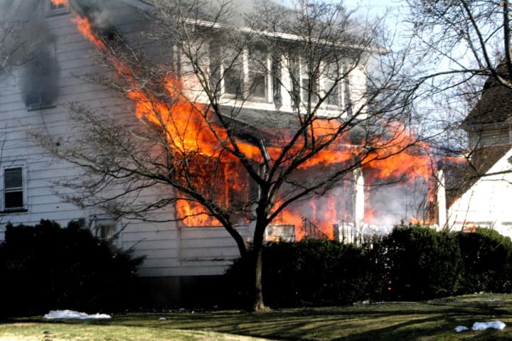 The two-alarm blaze ignited at the front of the nearly century-old wood-frame house on 5th Street off Morlot Avenue shortly before 2:30 p.m. Saturday, Feb. 24.