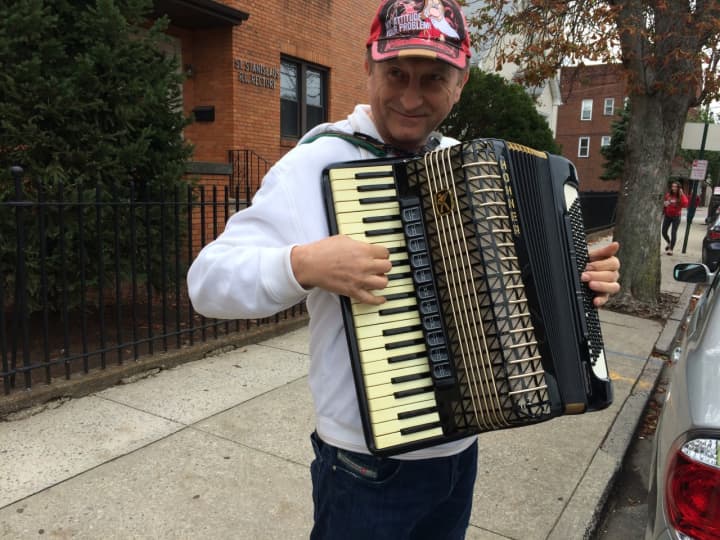 Stanistaw Nestoronicz plays the accordion before the start of the annual Pulaski Day Parade in Garfield Sunday morning, Oct. 4. 