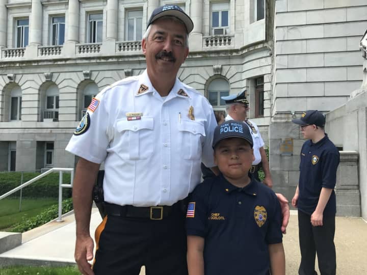 Park Ridge Police Chief Joseph Madden stands with &quot;Police Chief for a Day&quot; Angel Ocelotl.
