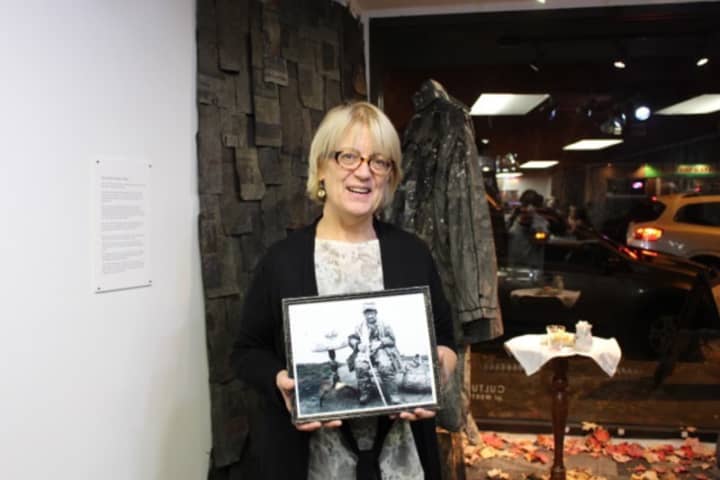 Susan McCaslin shows a photograph of the Leatherman, a man who lived in the region in the 19th century. Works in her new art exhibit at CAWC in Danbury are inspired by the stories of the Leatherman.