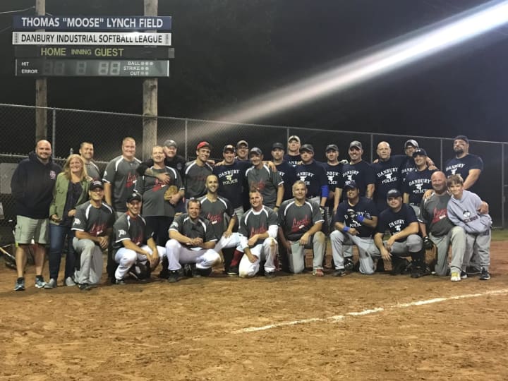 The Danbury Fire Department topped the Danbury Police Department in Friday&#x27;s charity softball game. Before the game, Field 2 was named for Danbury Firefighter Thomas &quot;Moose&quot; Lynch, who died in April.