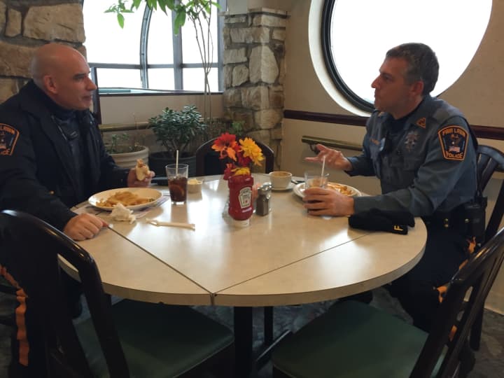Officers Rob Manning and Steve Buskiewicz enjoy soda and fries before returning to work.