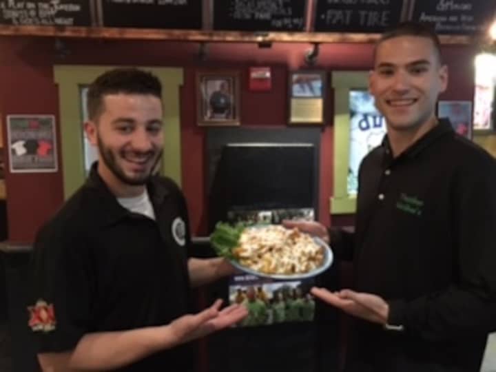 Alexio and Jordan, servers at Thatcher&#x27;s McGhee&#x27;s in Pompton Lakes, with the always popular Thatch fries.