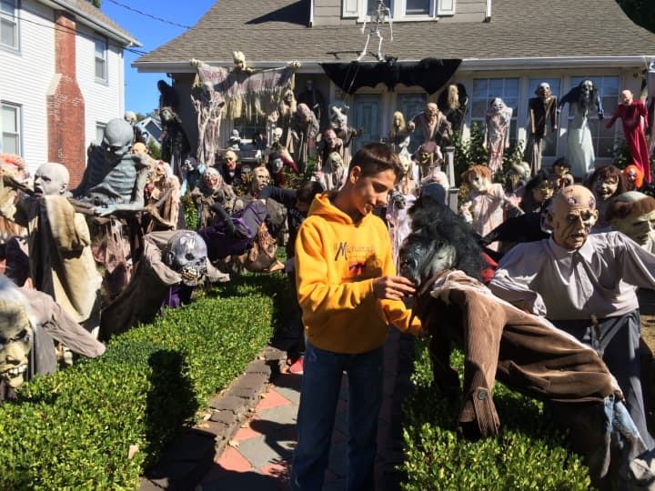 Phillip Rodrigues, 16, takes a stroll through the cast of characters in front of his Lafayette Avenue home in Hawthorne Sunday, Oct. 11. 