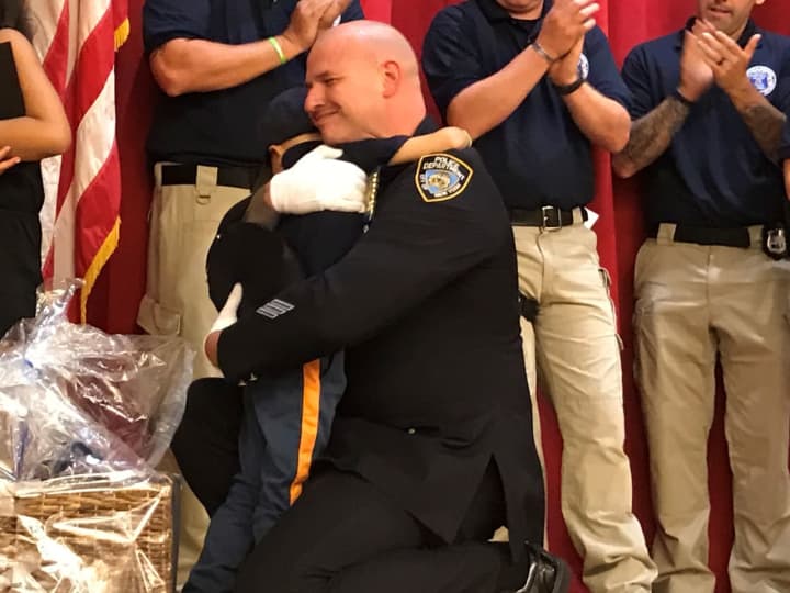 Alex Hammer, 4, hugs NYPD Detective Damian Majersky.