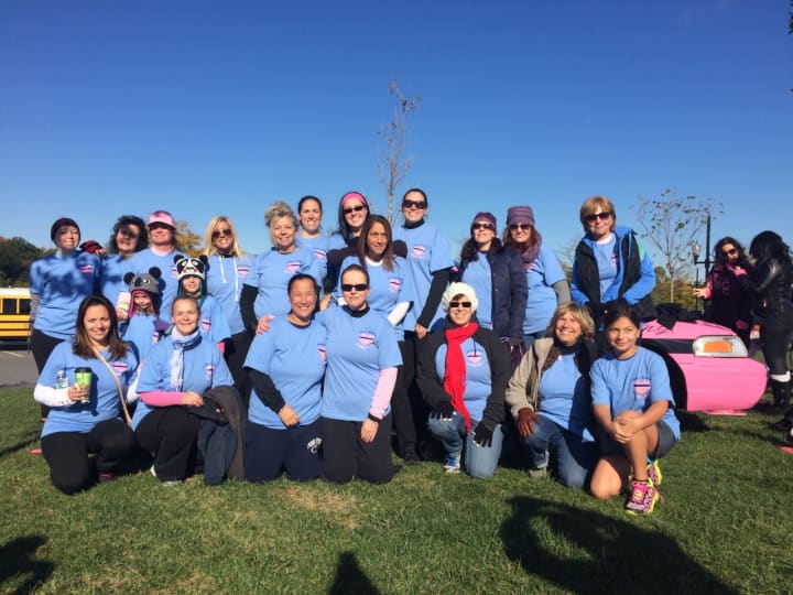 The 2015 Ladies in Blue Fighting in Pink team come together before the start of the Making Strides Against Breast Cancer walk in Overpeck Park on Sunday, Oct. 18. 