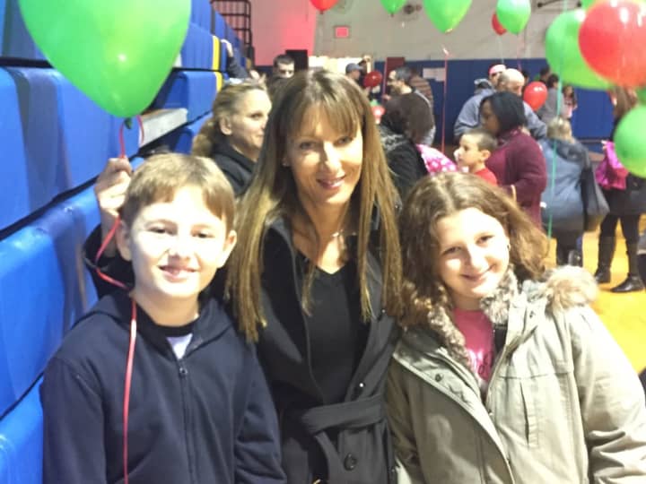 Regina Barrale stands with her children, Nicholas and Nina, in the Saddle Brook High School gym.